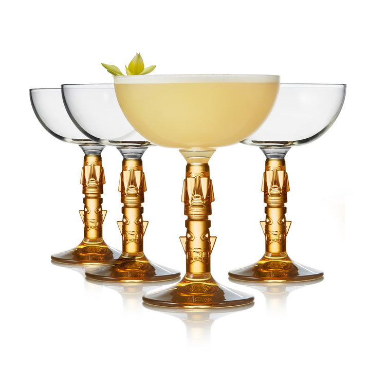 Vintage-style tiki coupe glasses with amber colored stem add a touch of elegance to your next summer celebration or tropical party